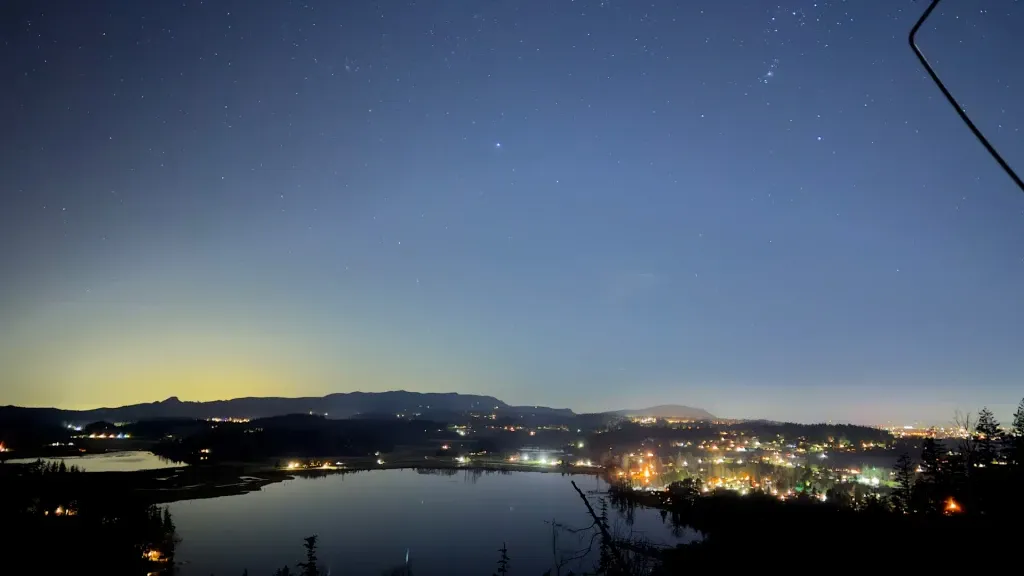 A tent under a starry sky over Clear Lake